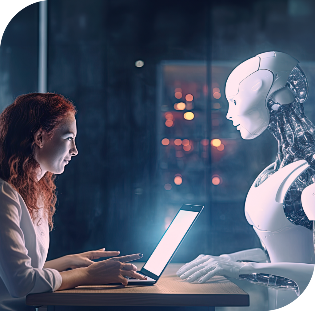 Frau vor Laptop sitzt vor Roboter
