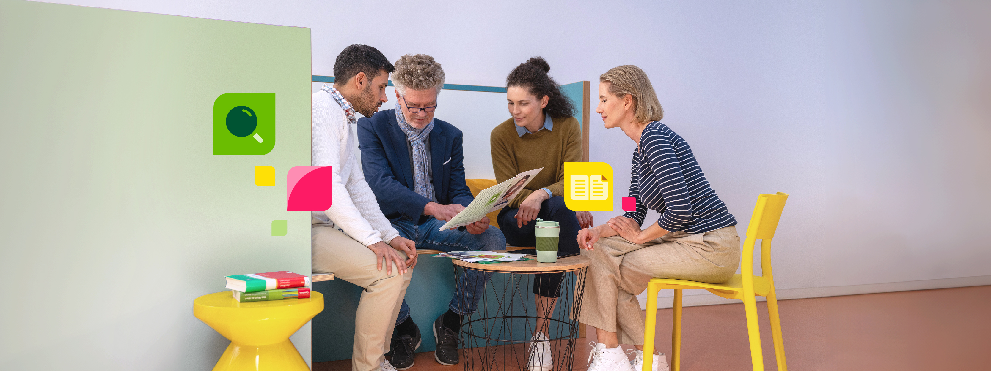 Personen sitzen an einem Tisch und betrachten ein Dokument